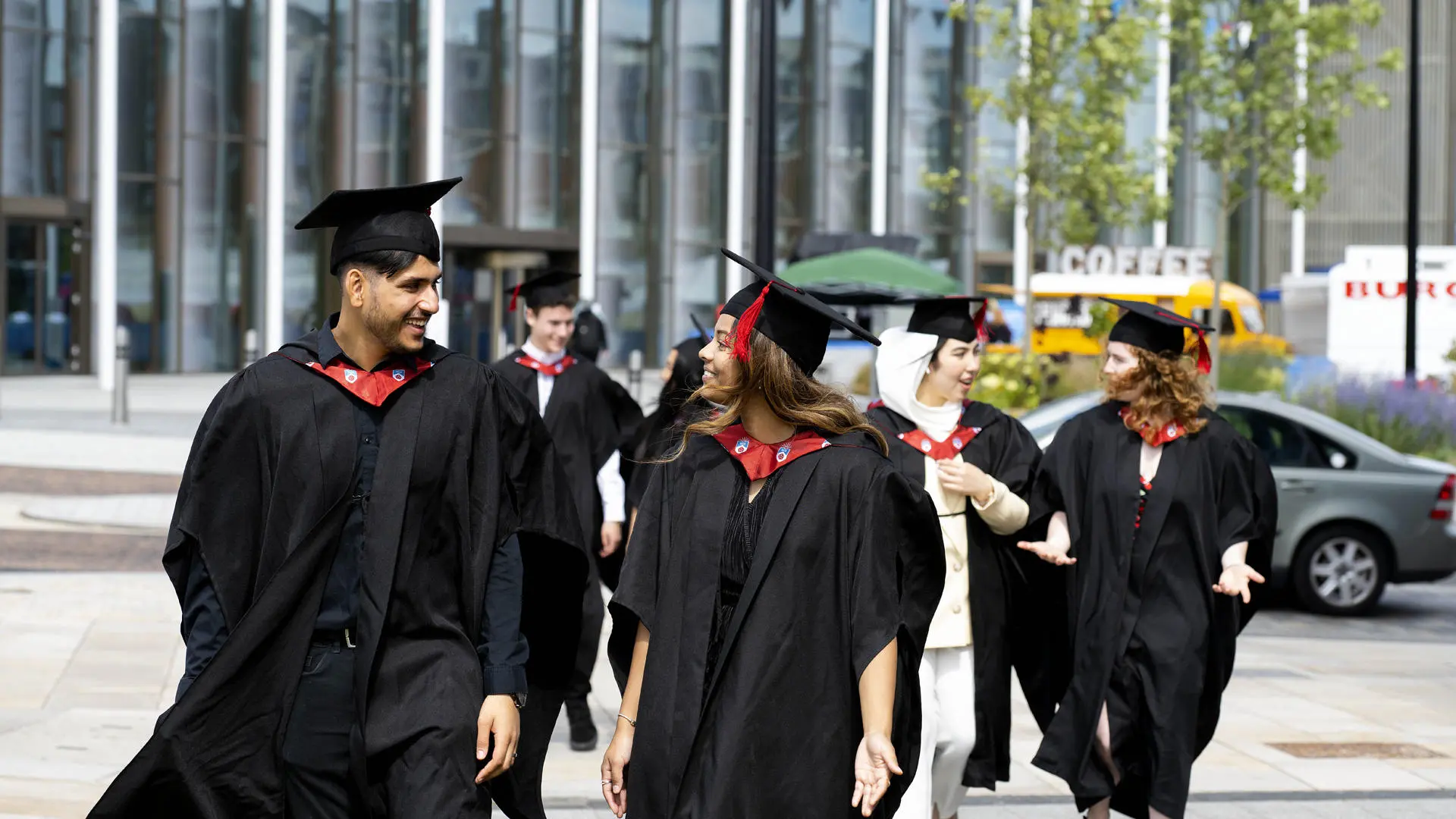 group of students walking in graduation caps and gowns