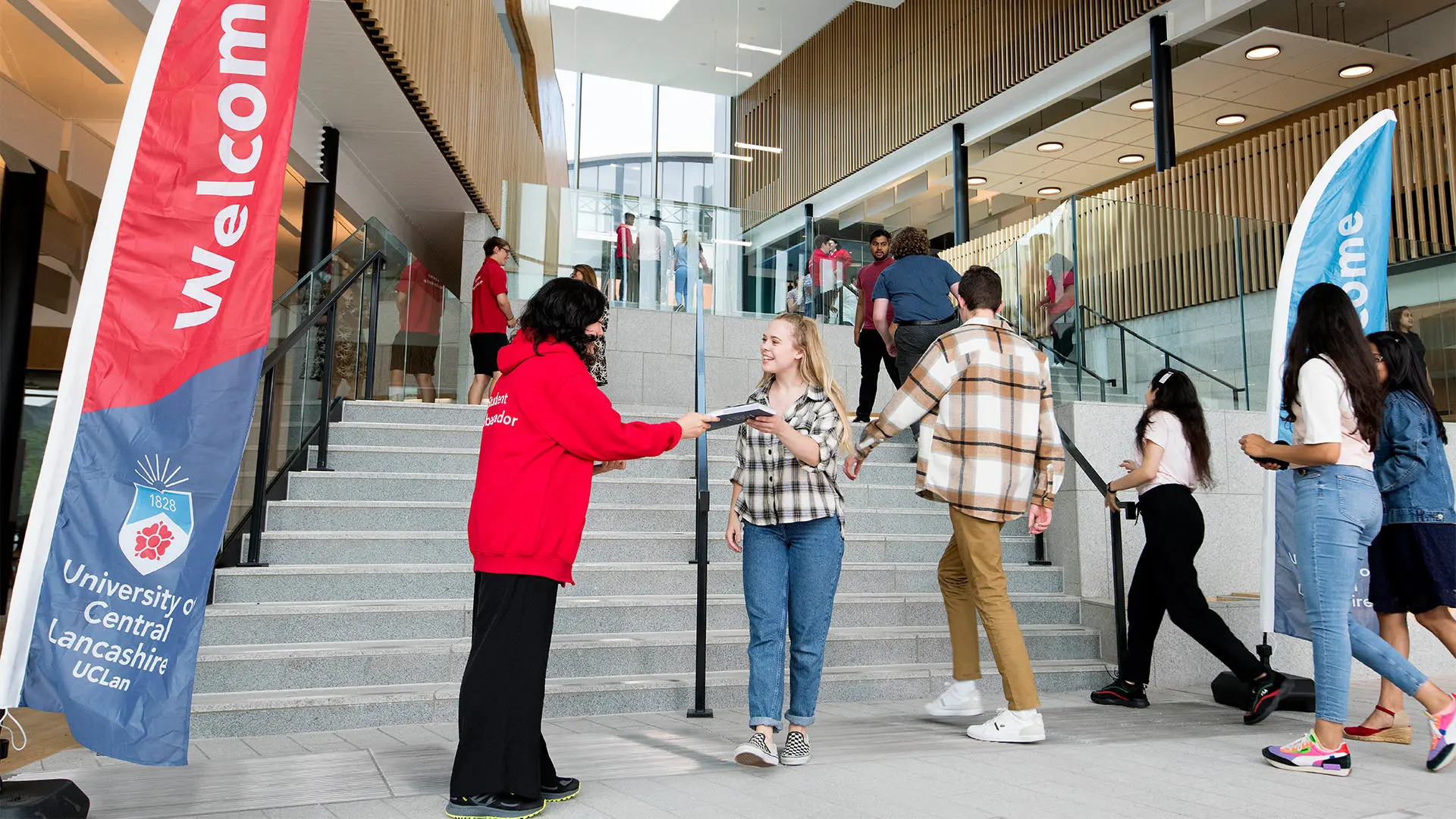 Student being greeted at an open day in the Student Centre