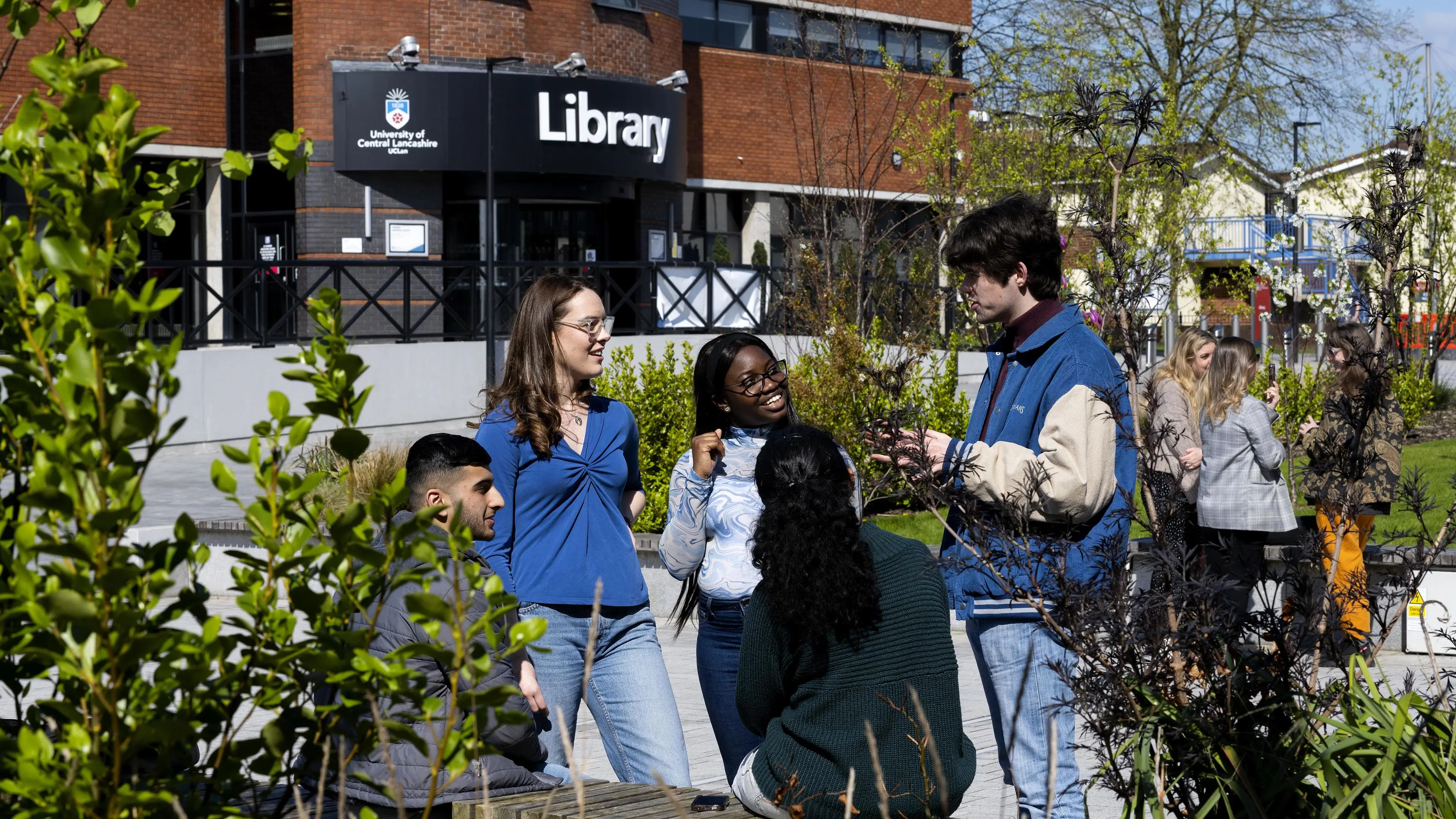 Students standing in a group outside the library building