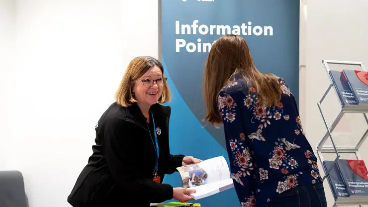 Open Day visitor using an information point