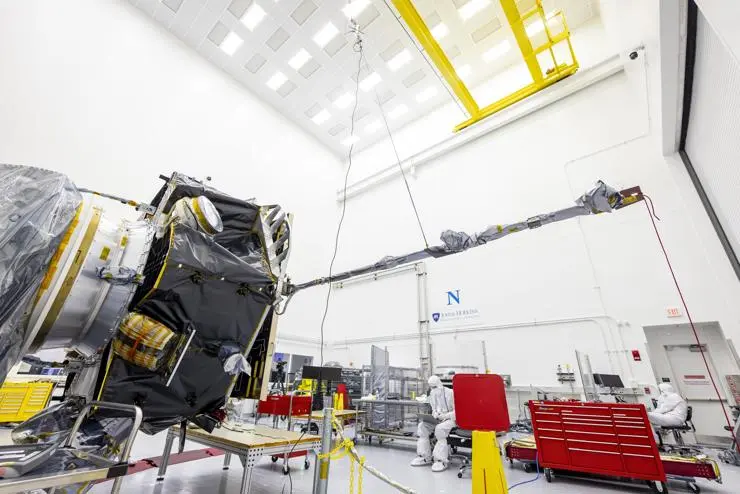 The magnetometer (MAG) boom is shown in the deployed position extending out from the Interstellar Mapping and Acceleration Probe (IMAP) at the Johns Hopkins App